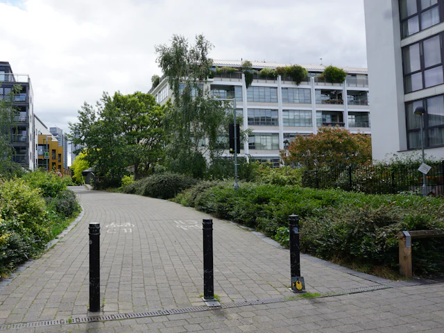 A landscaped walkway between apartment buildings